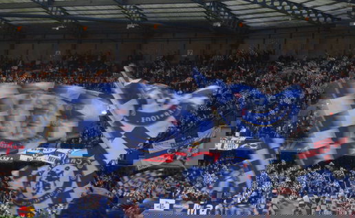 Chelsea fans celebrating at Stamford Bridge.