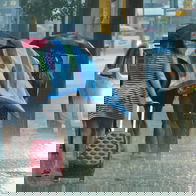 Image of people walking in the rain.