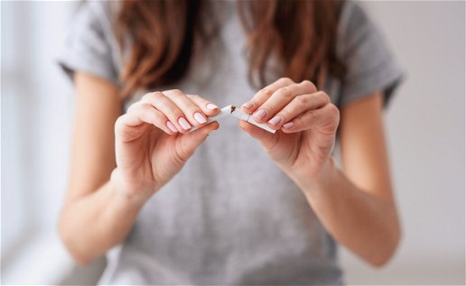 Image of a woman breaking a cigarette.