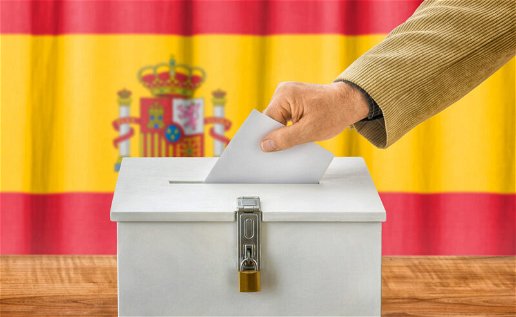Image of a person putting a paper into the ballot box in Spain.