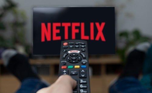 Image of Netflix and a remote control.