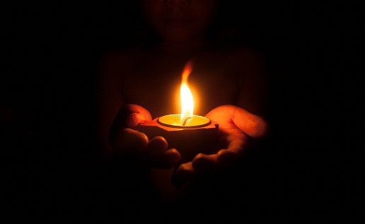 Image of a person holding a candle.