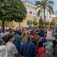 tourists watch a semana santa event in marbella