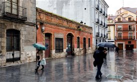 Image of people walking in the rain in Spain.