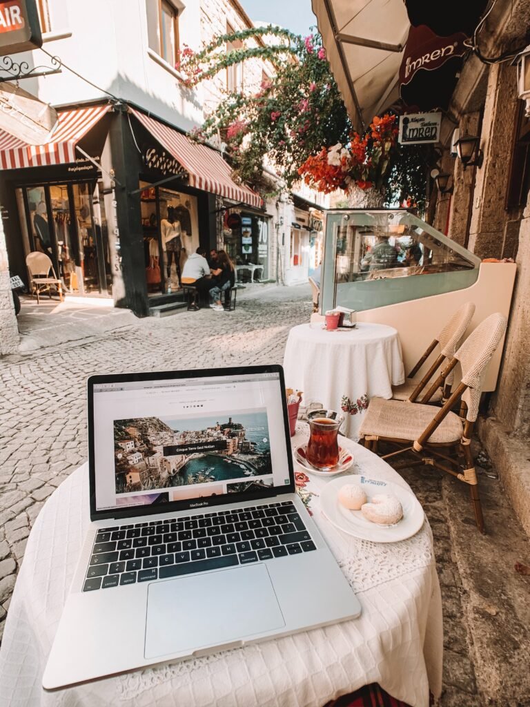 A laptop on a café table in a Mediterranean town