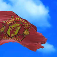 A flag with Manchester United's badge blowing in the wind.