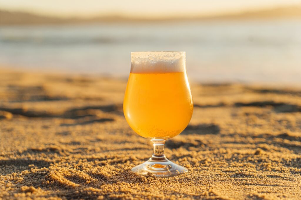 View of a cool Belgian beer on a sandy beech
