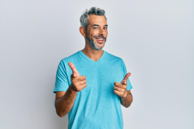 Middle aged man smiling and giving thumbs up to camera
