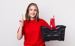 A smiling woman holding empty grocery basket