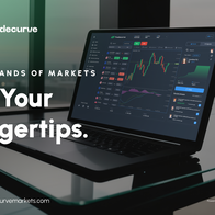 Laptop on a desk with picture on screen showing trading market graph
