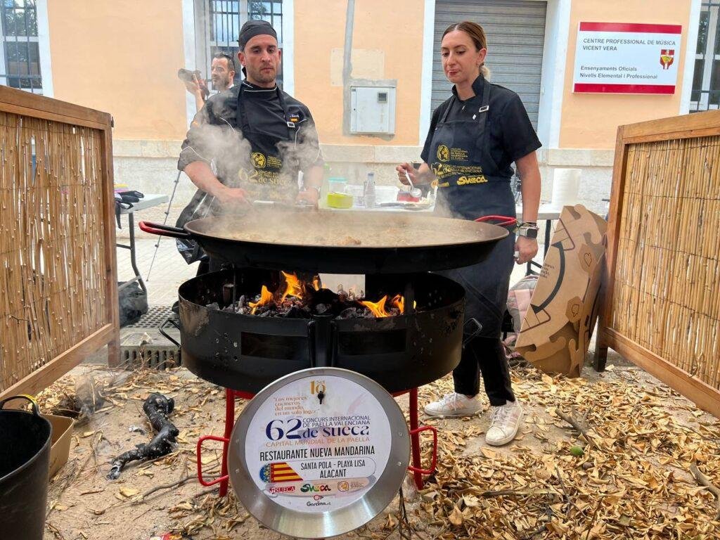 Two people making a paella