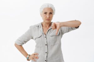 mature woman doing thumbs down sign