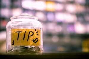 Jar with coins and label for tips