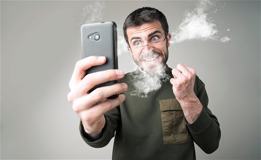 Image of a man angry with his mobile phone.