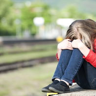 Image of a depressed young girl.