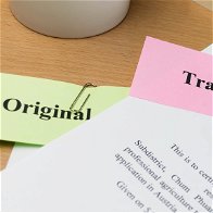 Papers on a desk with original and translation