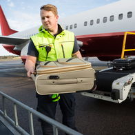 Image of an airport baggage handler.