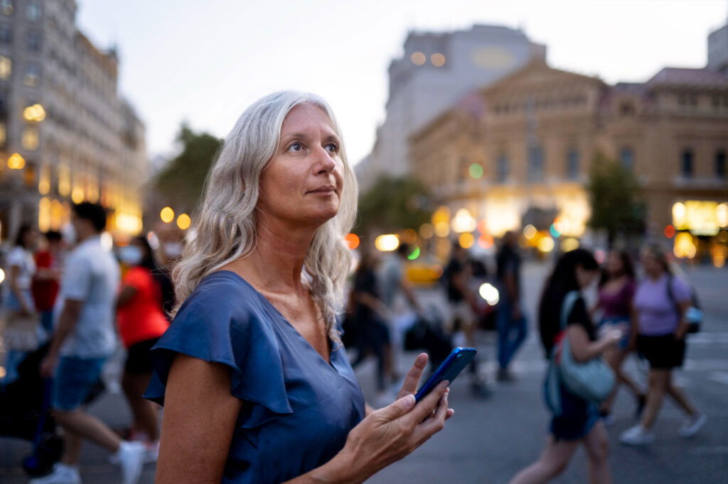 woman in foreground of busy city