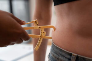 person having fat measured with calipers