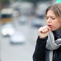Image of a girl coughing.