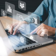 picture of someone at a laptop keyboard with floating icons