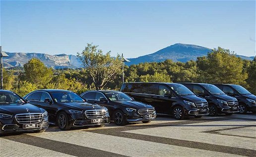 A row of high end cars for chauffeur services with a the background view blue skies and mountain view