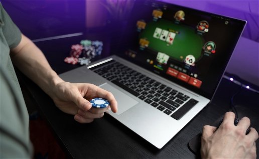 Young person in front of a laptop playing online poker
