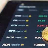 3 cryptocurrency coins on a tablet screen with rates