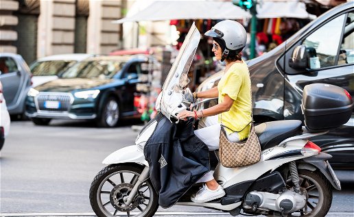 female on a vespa scooter in Rome