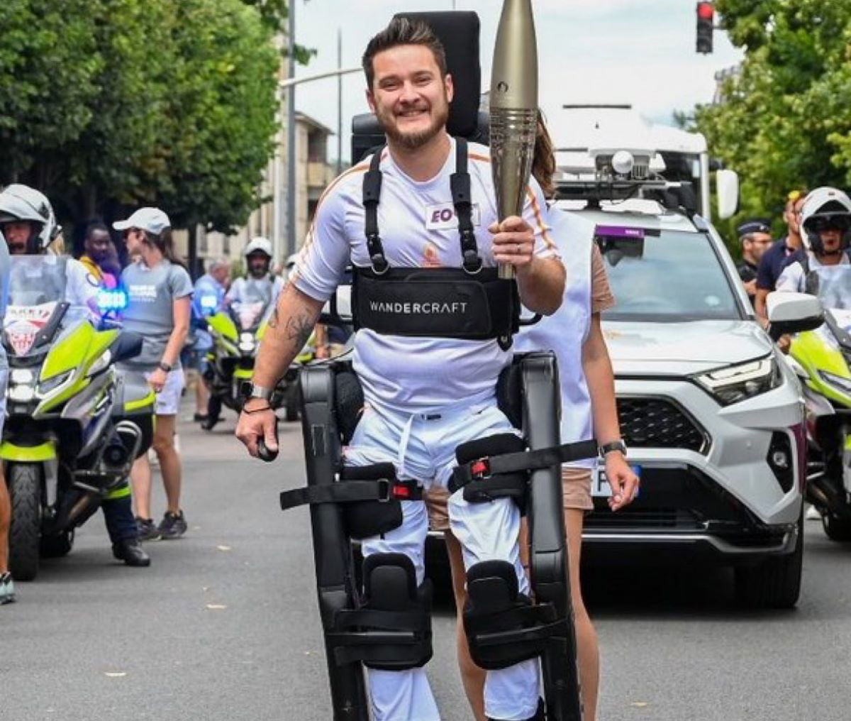 Paralympian Kevin Piette carries the Olympic Torch in a robotic