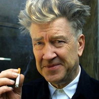 Close up of ageing man in a white shirt and black jacket smoking a cigarette