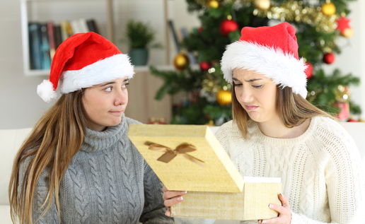 Woman opening gift she does not want.