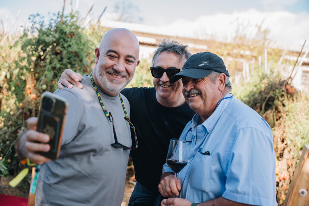 Chefs Diego del Rio and Jose Carlos Garcia pinch husbandman Pepe Álvarez.
