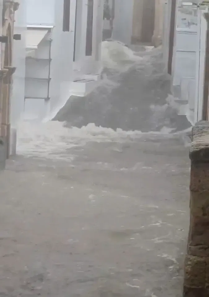Flood water coming down a street in Greece